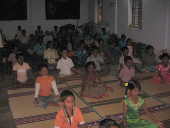 Students of Arivumaiyam practicing yoga